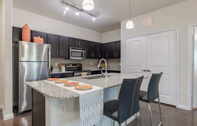 Kitchen Island with Stainless Steel Appliances and Cabinetry