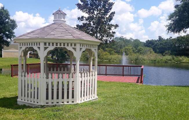 a gazebo with a lake in the background