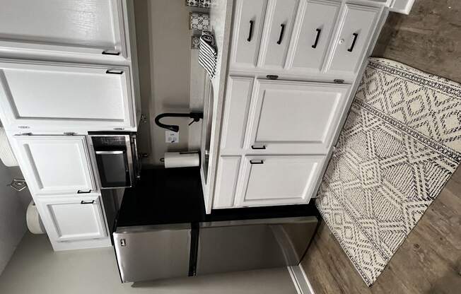 an overhead view of a kitchen with white cabinets