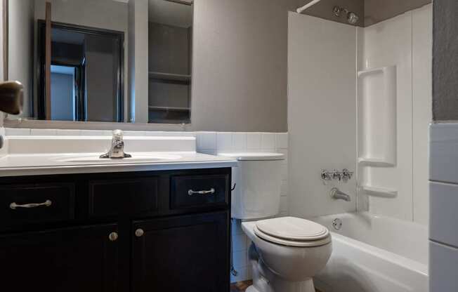 an empty bathroom with a toilet sink and tub. Roseville, MN Rosedale Estates Apartments