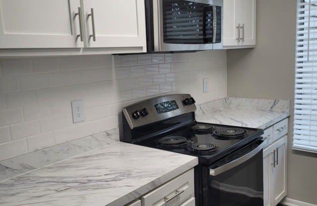 a kitchen with a stove and a microwave