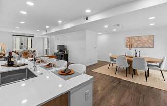 A modern kitchen with a dining table and chairs.