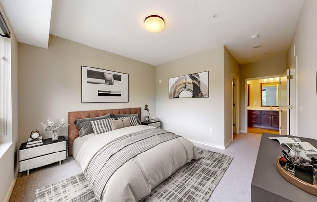 a master bedroom with a large bed and a bathroom