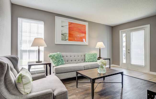 Westchase Apartments in Harvey LA photo of a living room with a couch and a table and hardwood floors