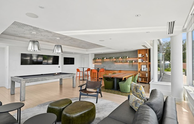 A modern living room with a grey sofa and a wooden coffee table.