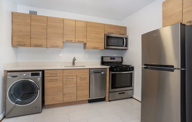 apartment kitchen featuring a dishwasher, refrigerator, and gas range stove