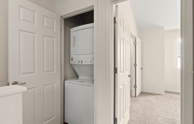 an empty laundry room with a washer and dryer in it