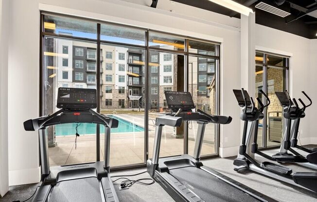 treadmills with view of pool in gym