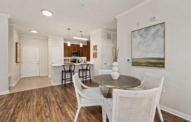 A dining room with a table and chairs.