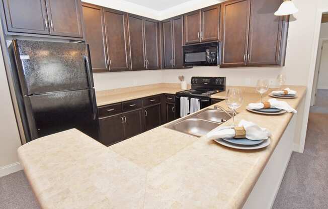 a kitchen with a large island and black appliances