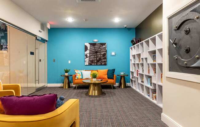 a living room with a blue wall and yellow furniture