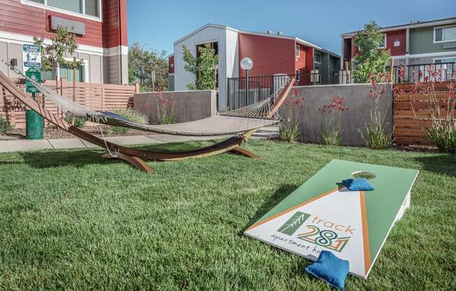 a yard with a hammock and a sign in the grass