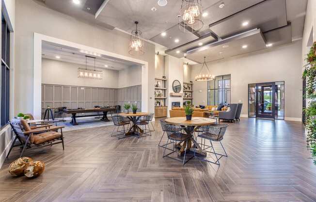 A modern living room with a dining area and a kitchen in the background.
