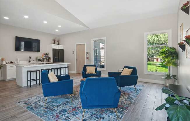 Community Clubhouse with Lounge Furniture and Kitchenette Area at Broadmoor Village Apartments located in West Jordan, UT.