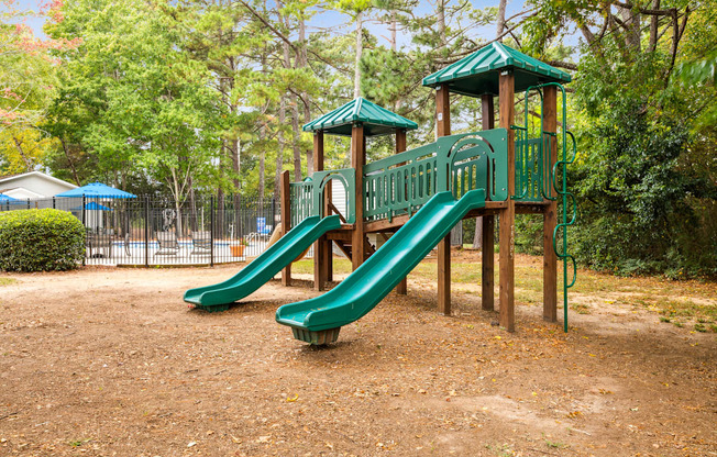 a playground with a slide at a park