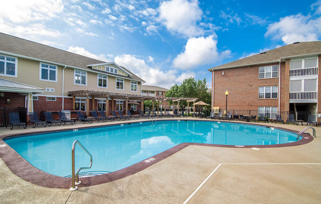 A swimming pool surrounded by a brick building.