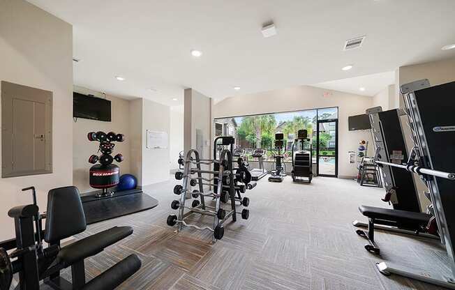 A gym with a variety of equipment including weights and machines.