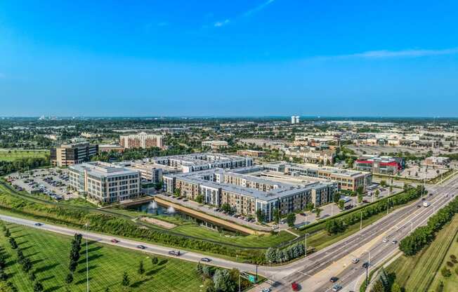 an aerial view of a city with buildings and a highway