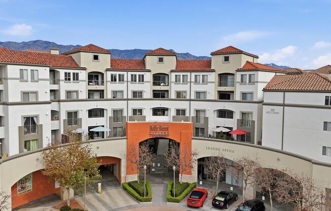 A large apartment complex with a red arched entrance.