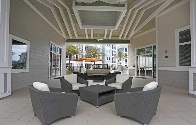 A patio with grey furniture and a white ceiling.