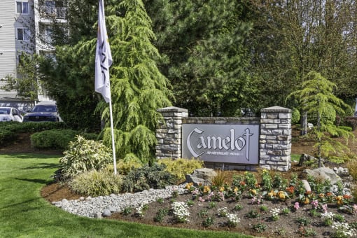 a sign in front of a building with a flag