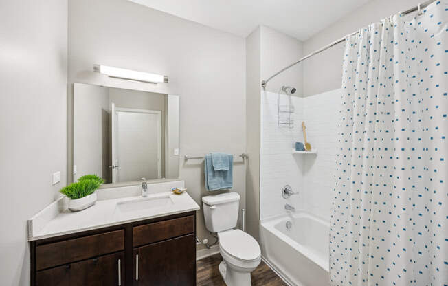 A bathroom with a white sink and a white toilet.