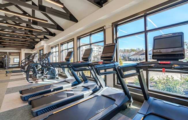 A gym with treadmills and exercise bikes.