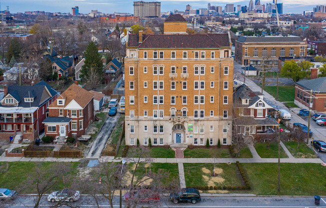 an aerial view of a building in front of a city