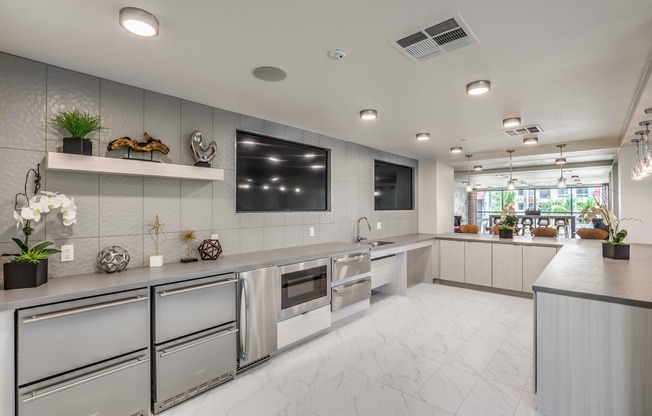 Clubroom Lounge and Dining Area with large kitchen with island and stainless steel appliances at arte apartments