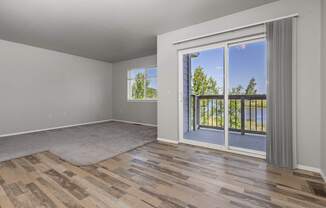 A room with a sliding glass door leading to a balcony.