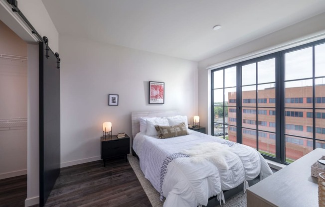 a bedroom with a bed and a large window at The Audubon New Haven, New Haven, CT, 06511