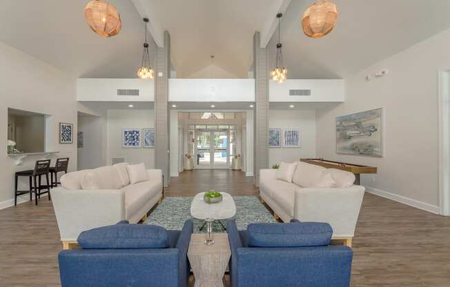 a living room with couches and chairs and a table