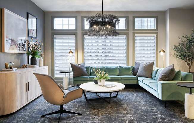 a living room with a green couch and a table