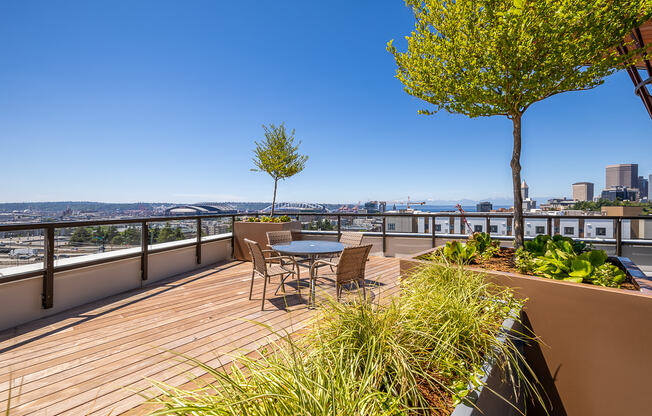 a deck with a table and chairs and a view of the city