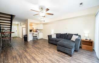 a living room with a couch and a ceiling fan