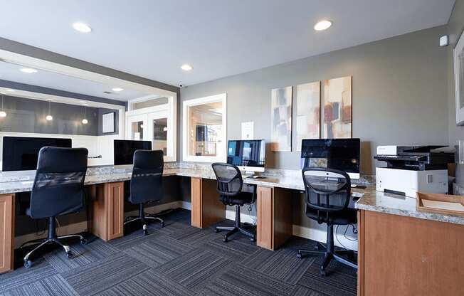 an office with desks and computers and chairs