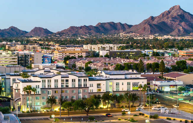 A cityscape with buildings and a mountain in the background.