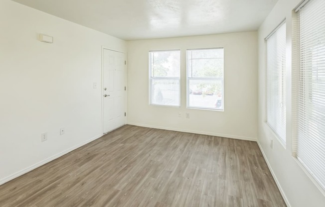 an empty room with a large window and a floor with a patterned flooring