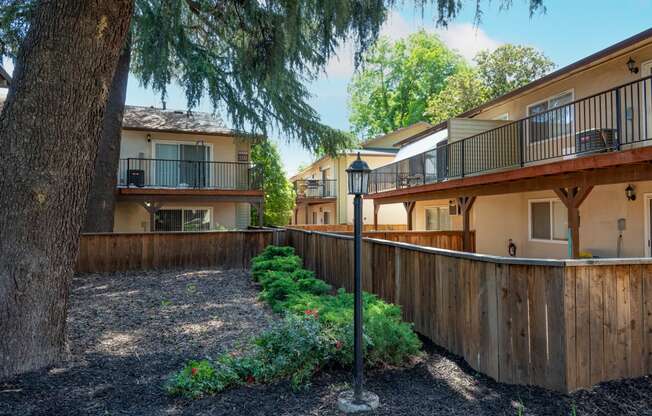 View of private patio/balcony and trees providing shade