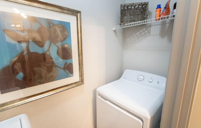 This is a photo of the utility closet with washer and dryer connections in the 826 square foot 1 bedroom , 1 bath apartment at The Brownstones Townhome Apartments in Dallas, TX.