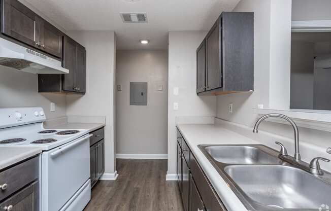 the preserve at ballantyne commons apartment kitchen with white appliances and dark cabinets