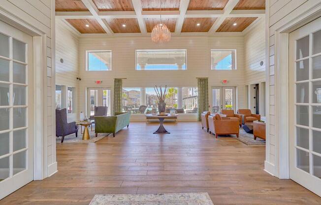 a large living room with a wooden floor and large windows at Cypress River, Ladson