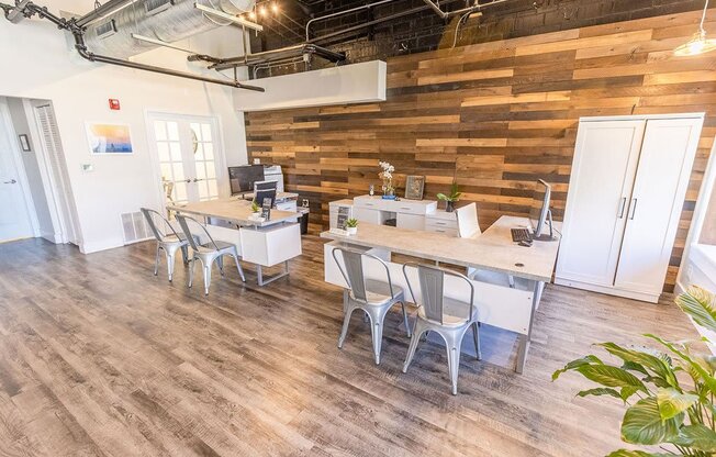 an office with a wooden wall and hardwood floors