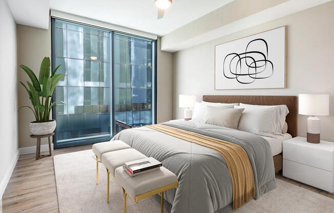 Spacious bedroom retreats feature modern ceiling fans, wood plank style flooring, and oversized windows for a bright and calming atmosphere.