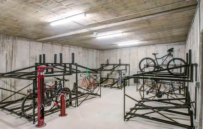 a storage room with bikes on racks in it