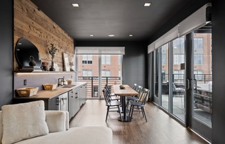 a kitchen and dining area with a table and chairs and sliding glass doors