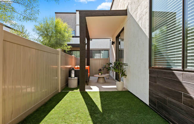 a courtyard with grass and a toilet in a house