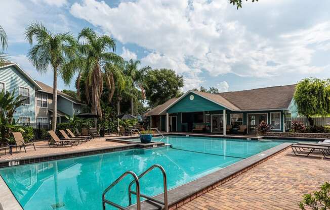 a swimming pool with a house in the background