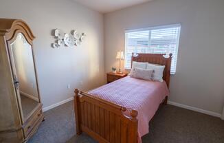 a bedroom with a bed and a mirror