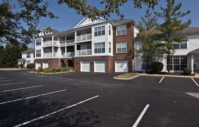 A parking lot in front of a two story apartment building. at The Orchard, Dublin, 43016
